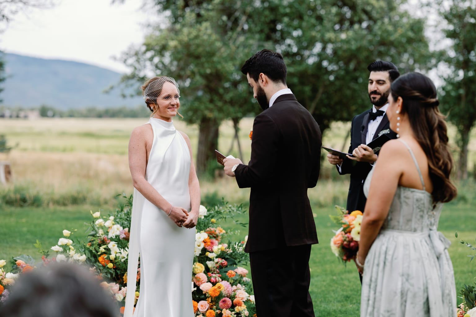 Vows in the meadow with peach and marigold florals, a 4U Ranch wedding in Park City, Utah