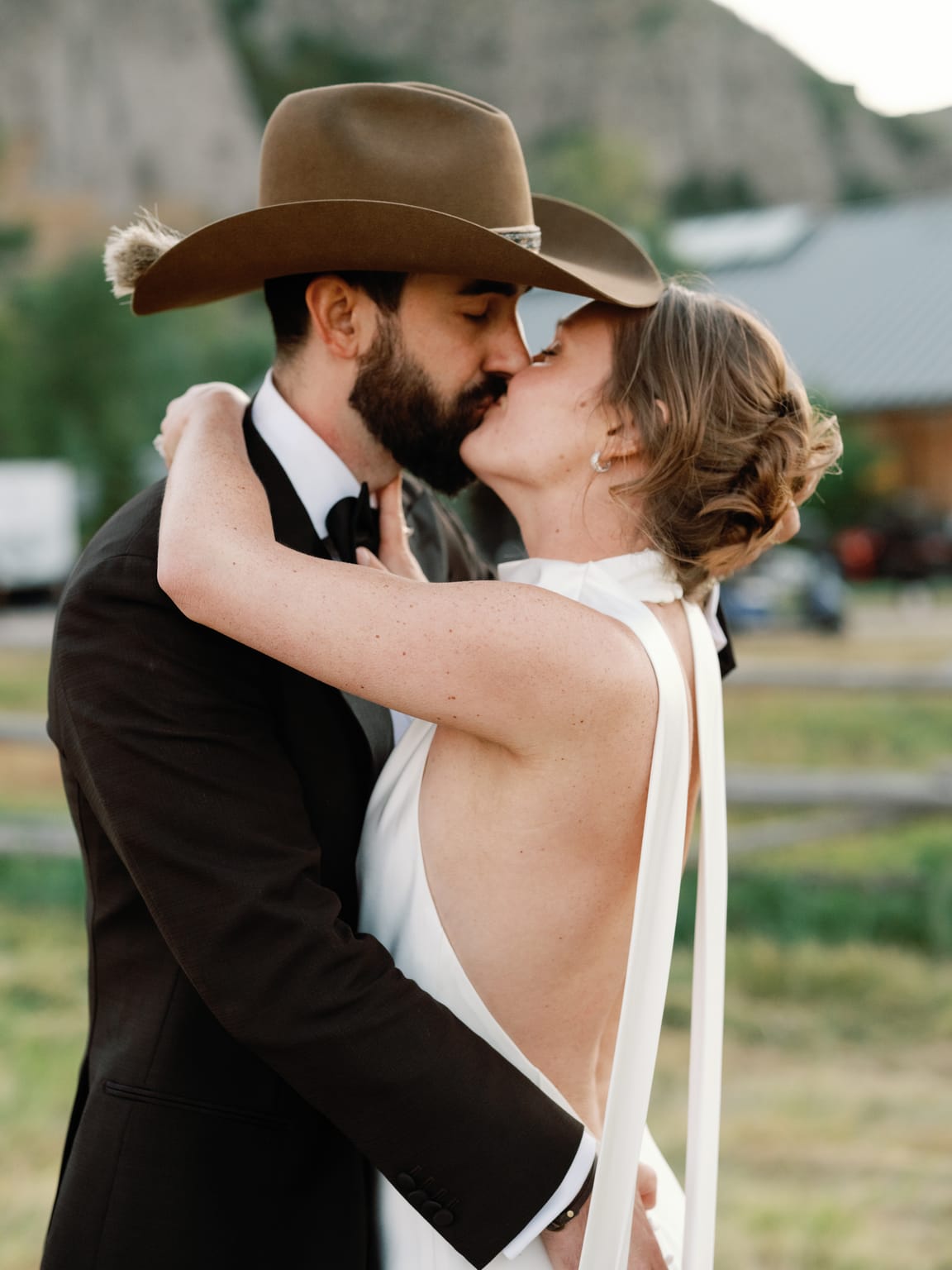 The groom in a cowboy hat dips the bride for a kiss, 4U Ranch wedding in Park City, Utah
