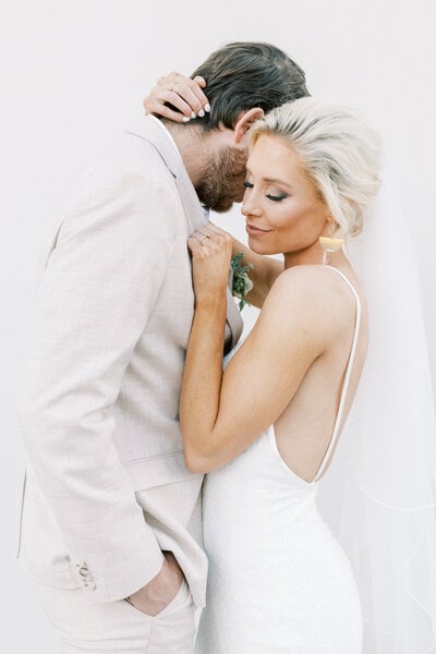 A bride leans into her groom, eyes closed, in a quiet close embrace at Wild Oak in Lindon, Utah