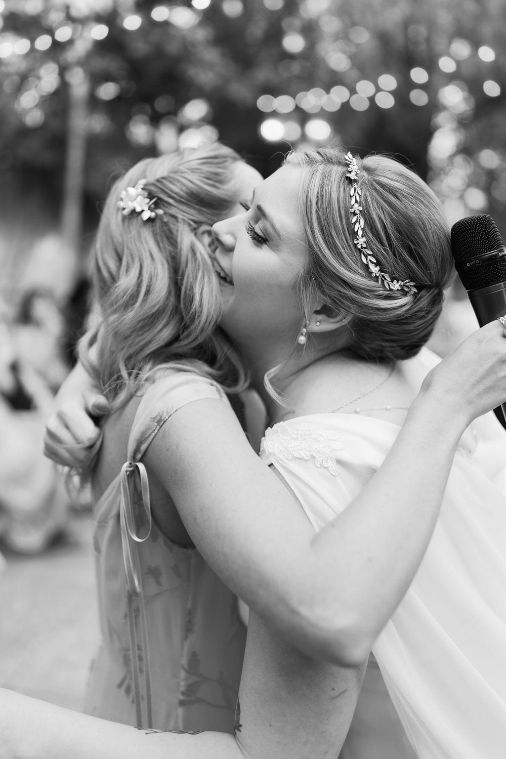 An embrace during the toasts at Eldredge Manor, black and white