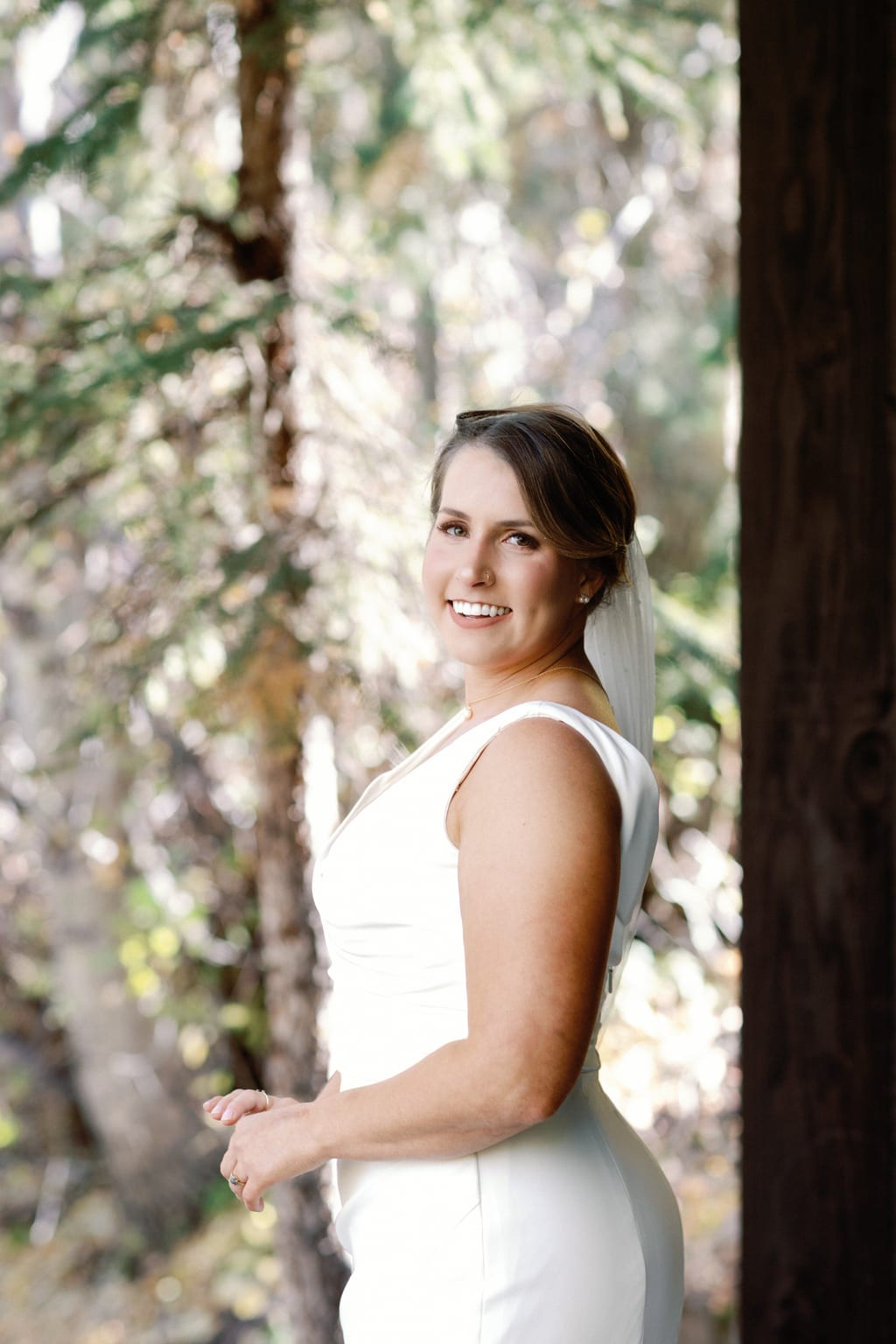 The bride smiling among the pines, mountain wedding in Sundance, Utah