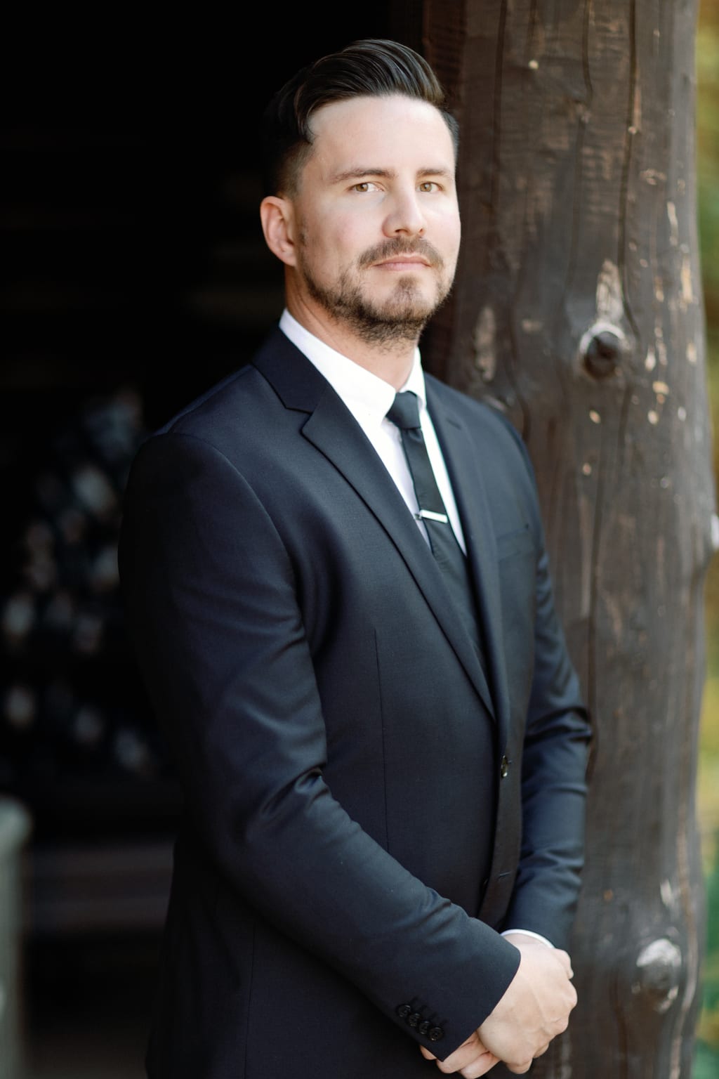 The groom standing among the pines before the ceremony, Sundance, Utah