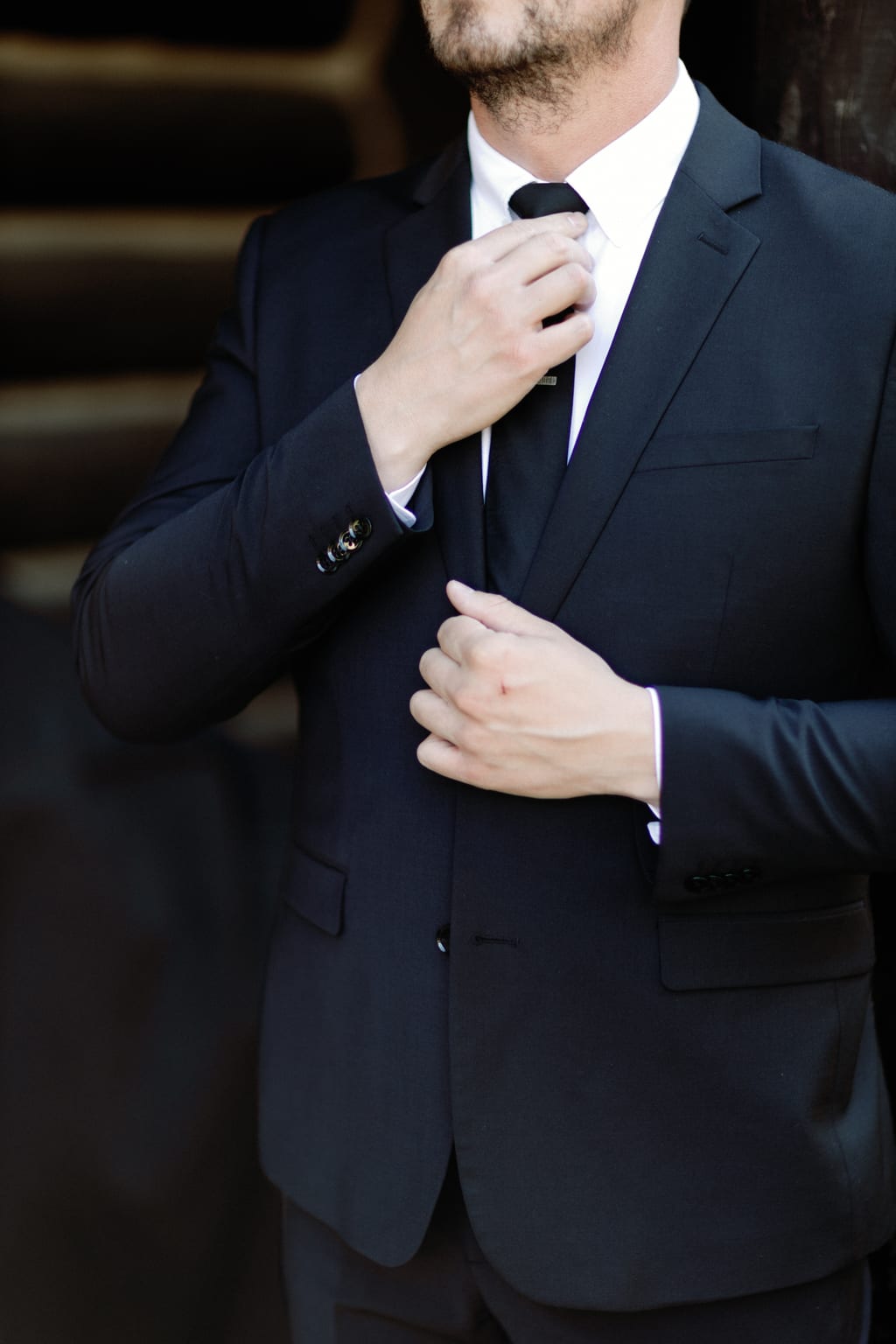 The groom adjusting his tie, wedding-morning detail, private Sundance residence