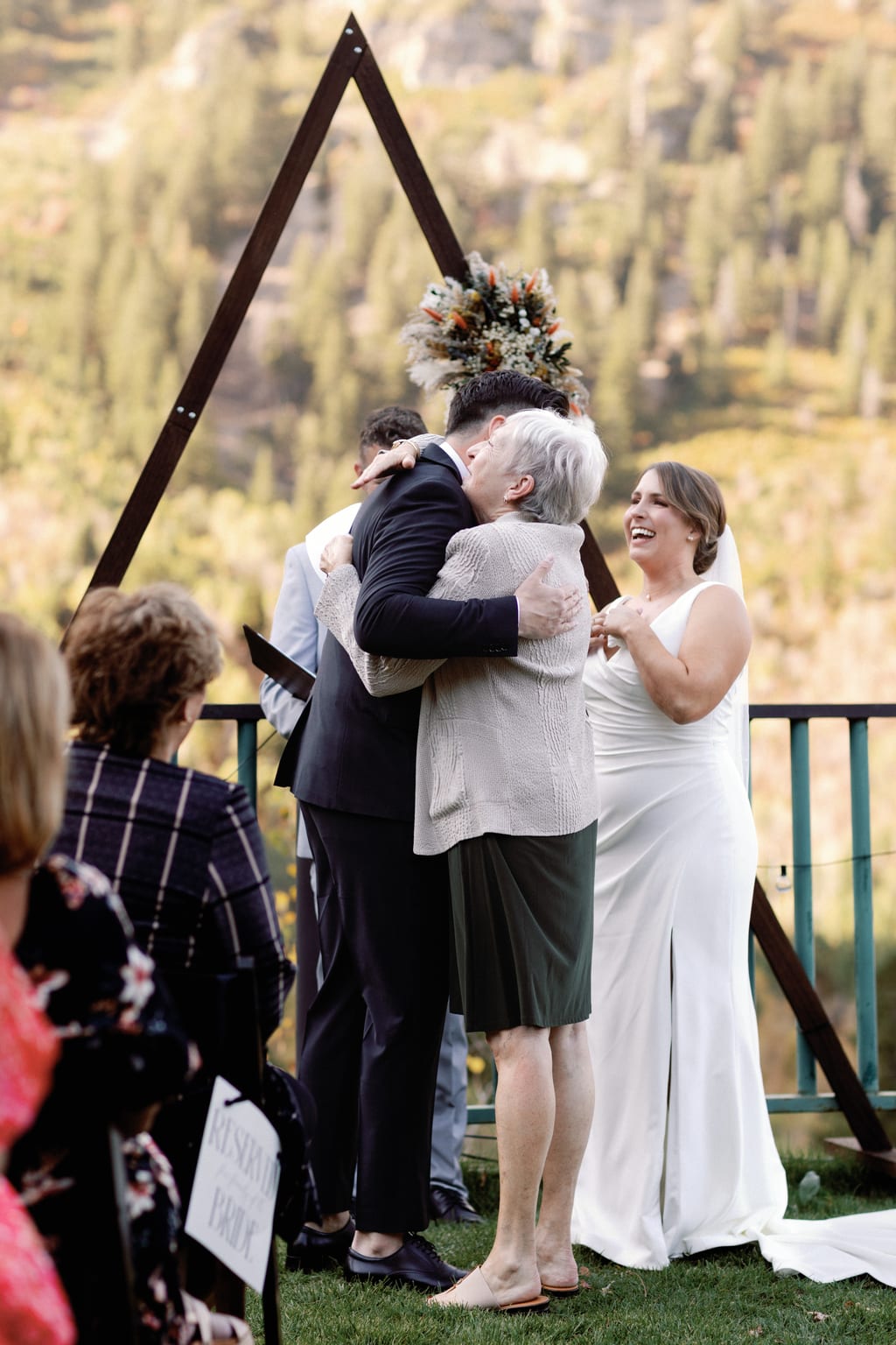 The embrace at the close of the ceremony, surrounded by guests, Sundance, Utah