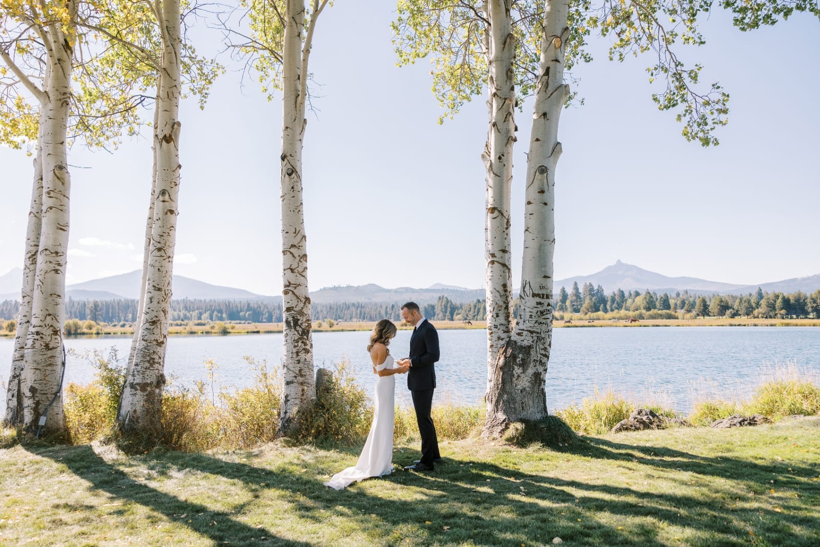 Couple by lake with Utah mountains